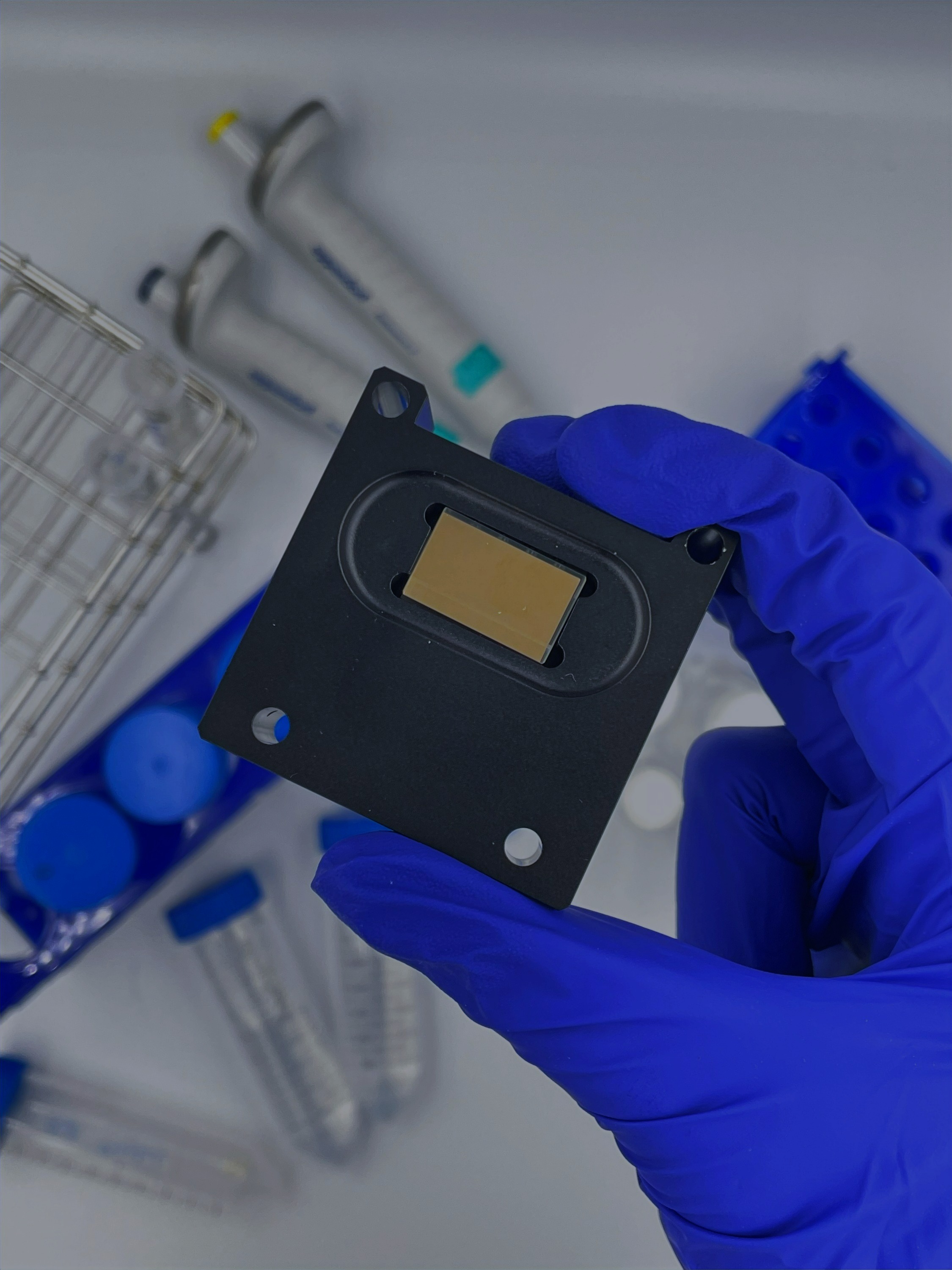 Lensless SPR sensor tray — the gold-film sensor chip seated in the Affinité instrument tray, held in a lab setting